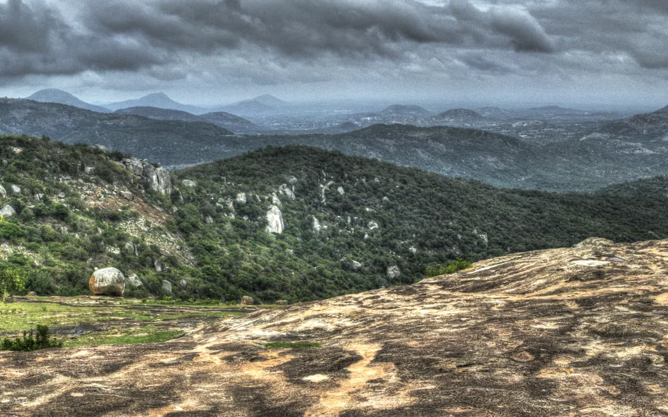 Rocky slopes and distant countryside seen from Horsley Hills.