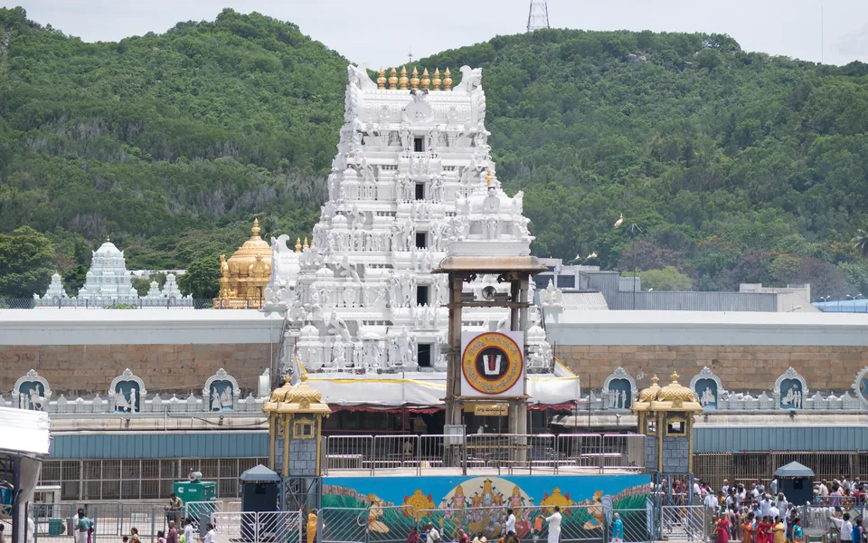 White temple towers against the wooded hills at Tirumala.